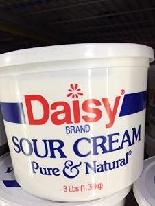 White tub of sour cream made by Daisy